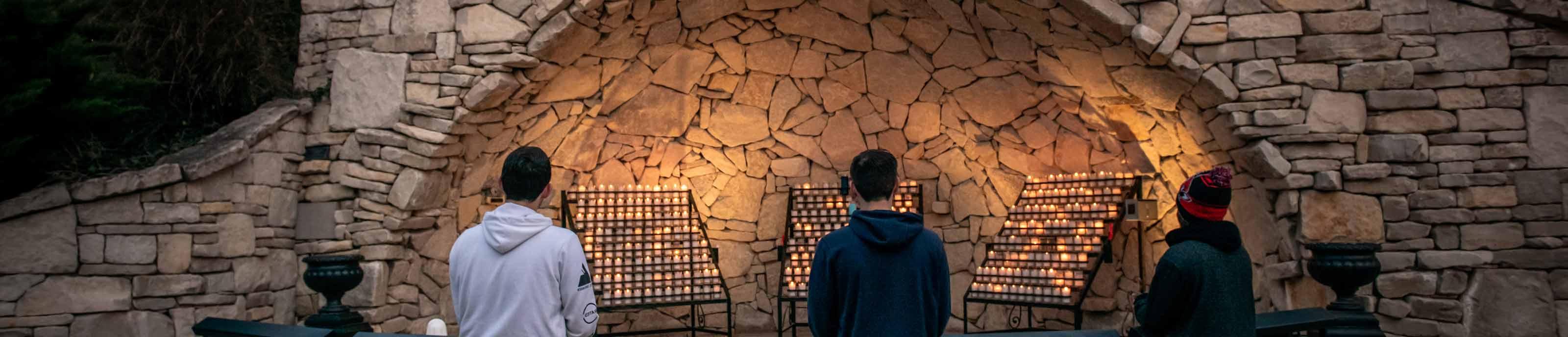 Students praying at Mary's Grotto